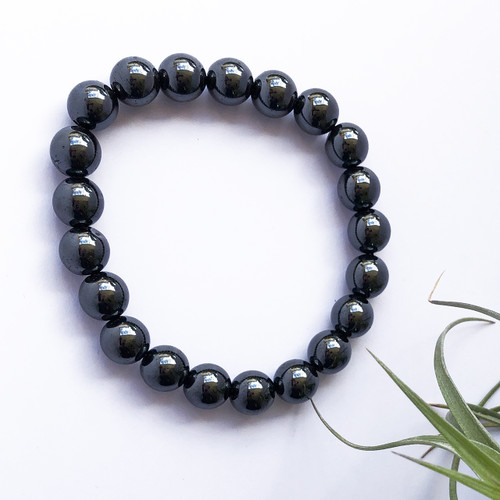 Hematite 10mm Bead Bracelet on white background with air plant